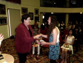 A student receives her award
