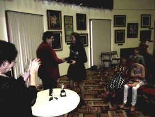 A student receives her award